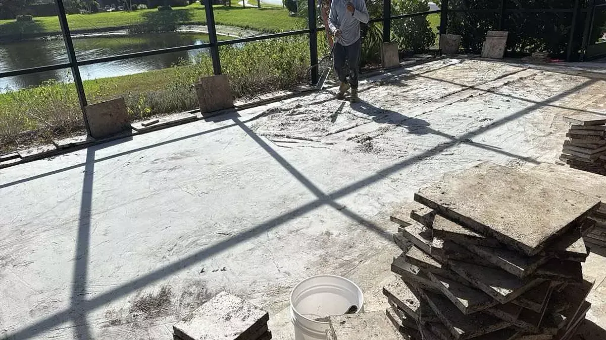 Paver lanai floor lifted for repair in Venice, Florida with pavers stacked for reset