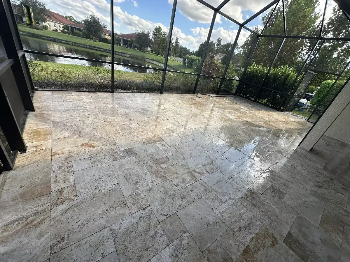 Repaired and releveled paver lanai floor beside a pool enclosure in Venice, Florida